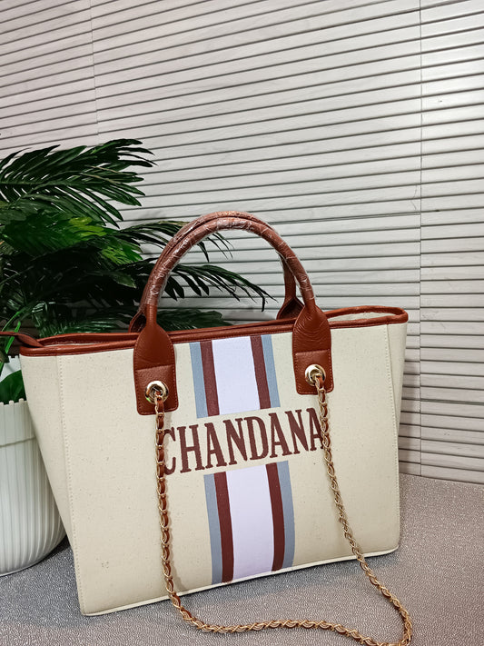 Off-white bag with grey, brown and white stripes