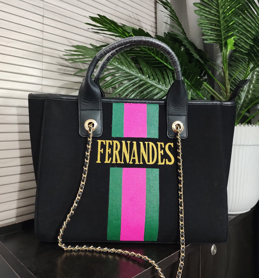 Black bag with green and hot pink stripes