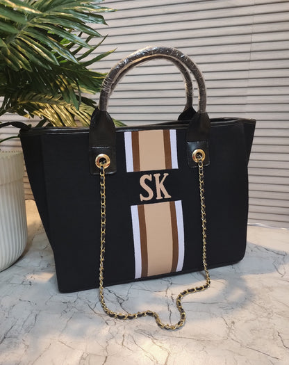 Black bag with white, brown and beige stripes