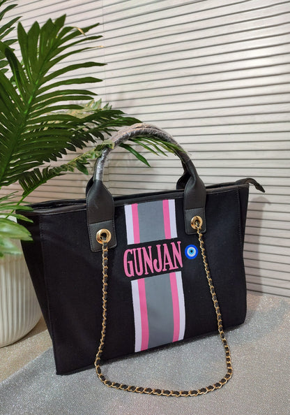 Black bag with white, pink and grey stripes_