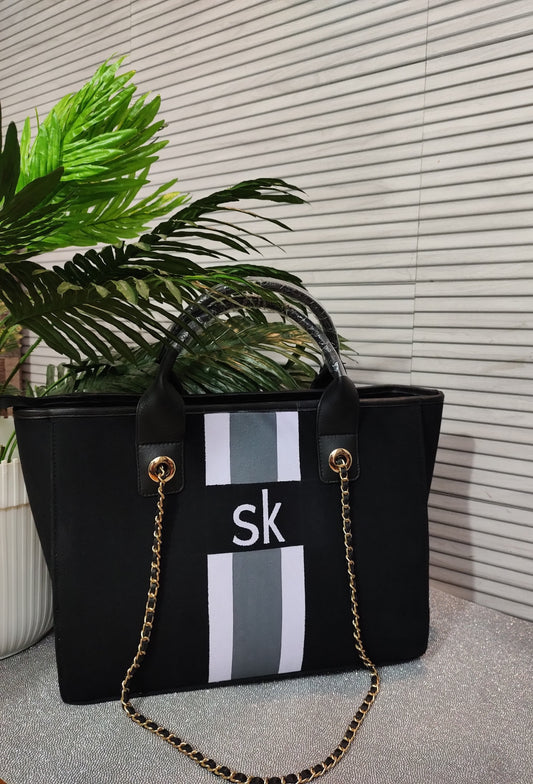 Black bag with white and grey stripes