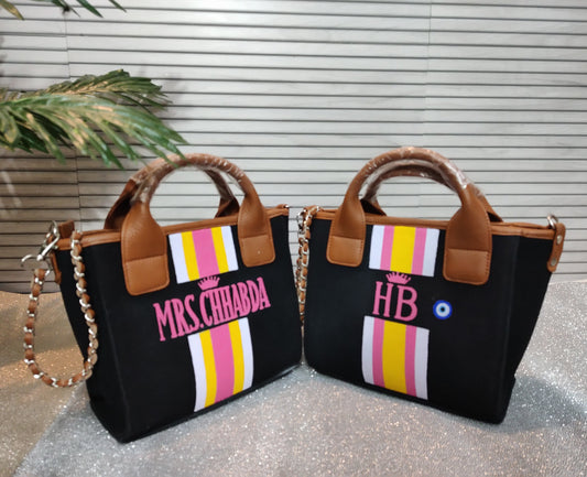 Black mini bag with white, yellow and pink stripes