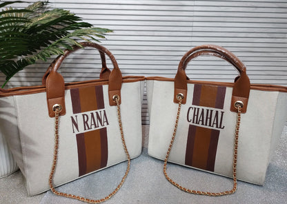 Dark beige bag with white, navy and brown stripes