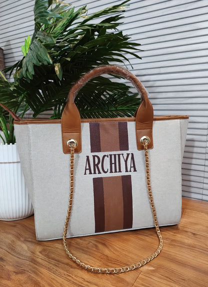 Dark beige bag with white, navy and brown stripes