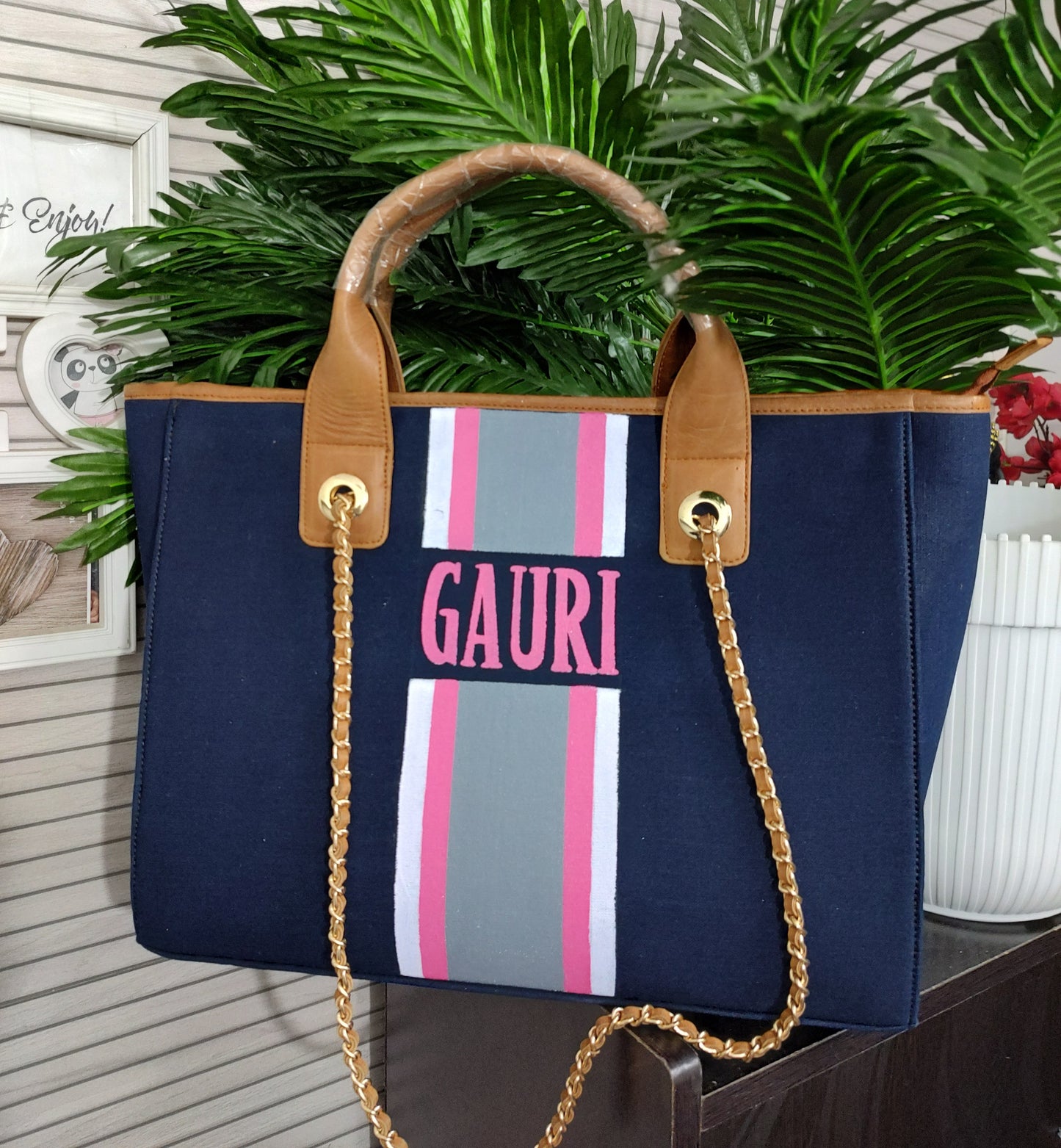 Navy blue bag with white, baby pink and grey stripes