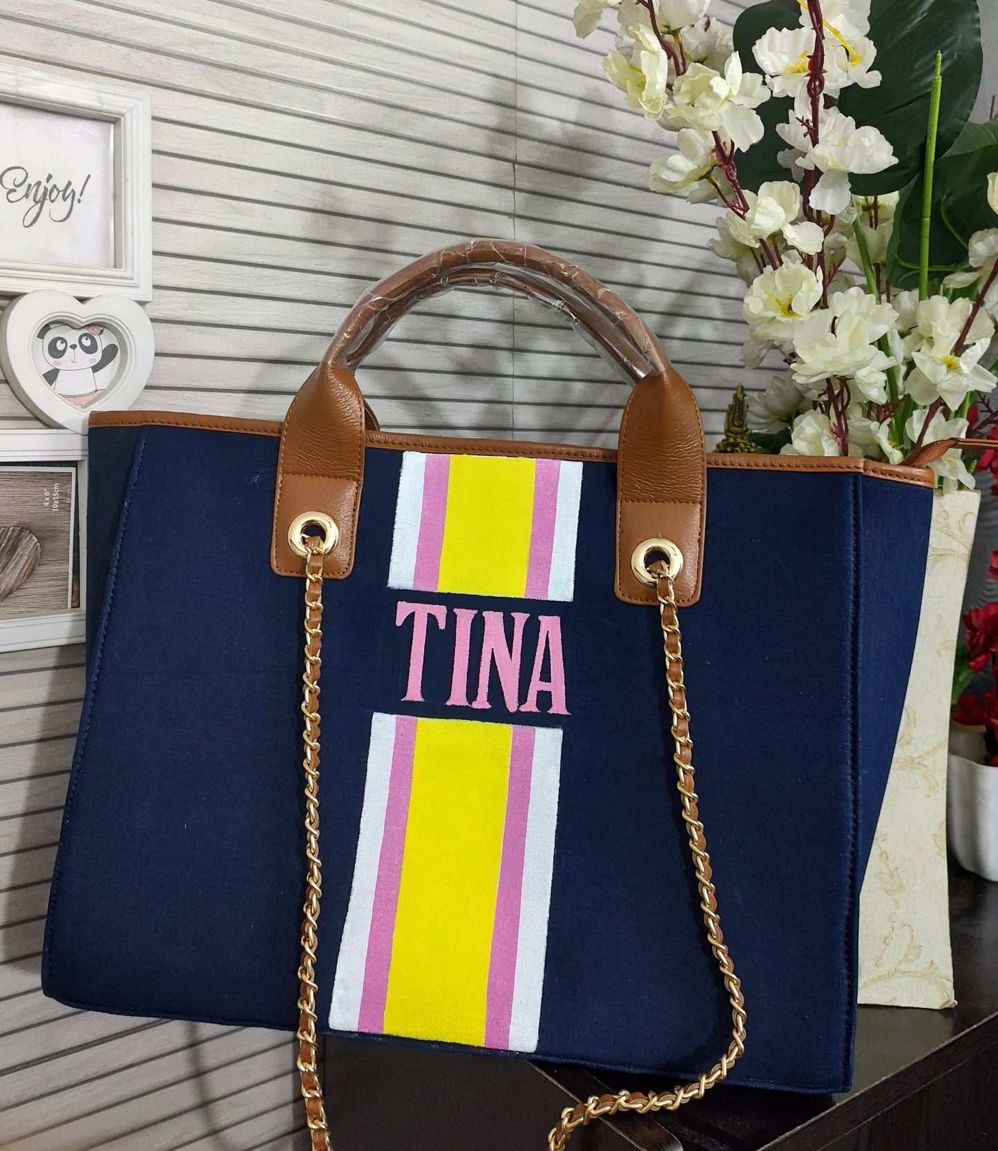 Navy blue bag with white,pink and yellow stripes