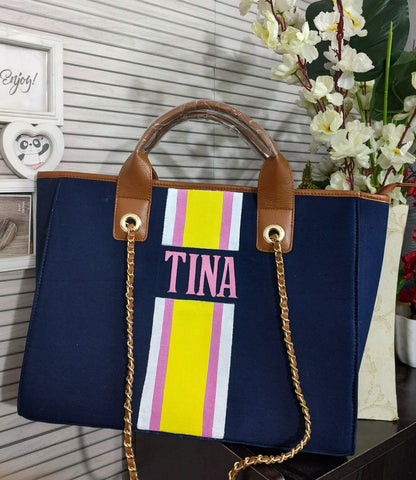 Navy blue bag with white,pink and yellow stripes