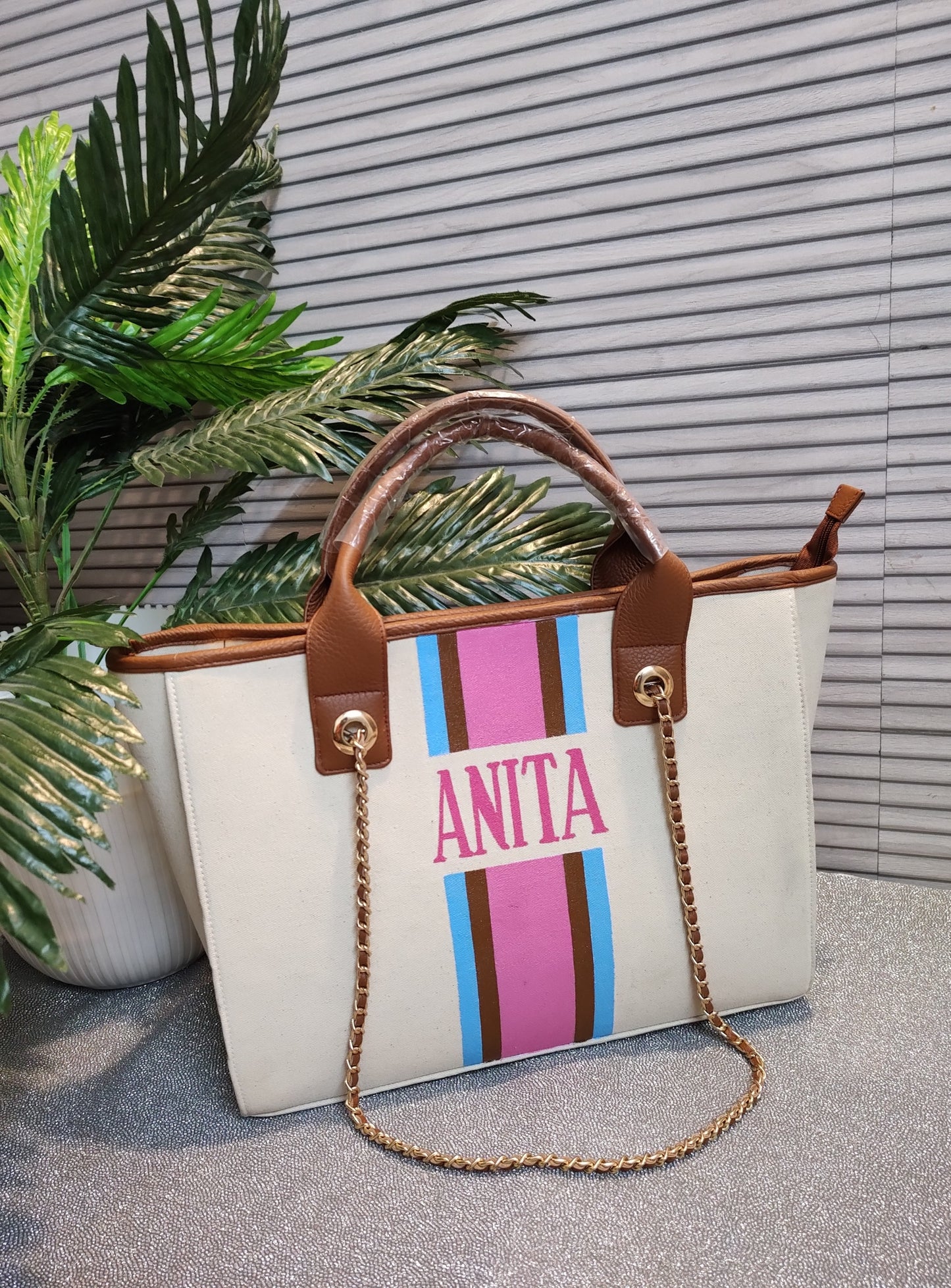 Off-white bag with sky blue, brown and pink stripes