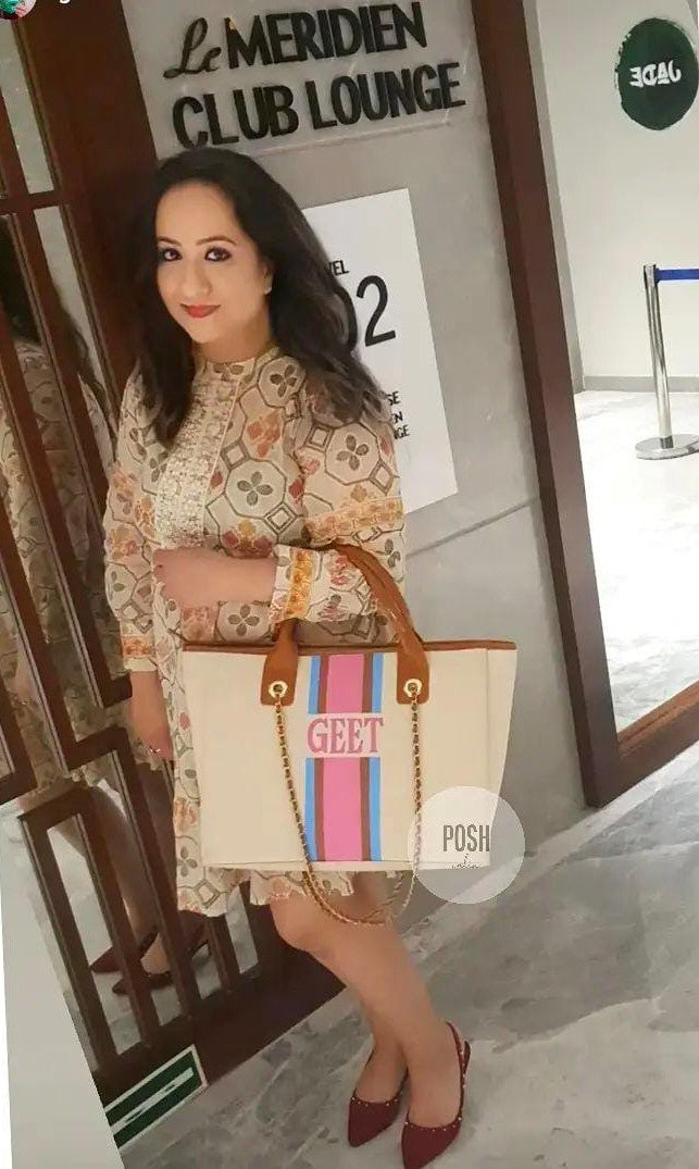 Off-white bag with sky blue, brown and pink stripes